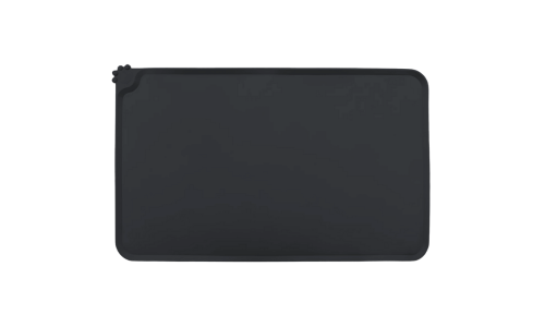 Waterproof silicone cat feeding mat in black with raised edges to stop spills from reaching and damaging your floor.