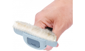 Stainless steel blade of cat grooming deshedding comb in grey and blue, packed with loose fur after brushing, for cats.